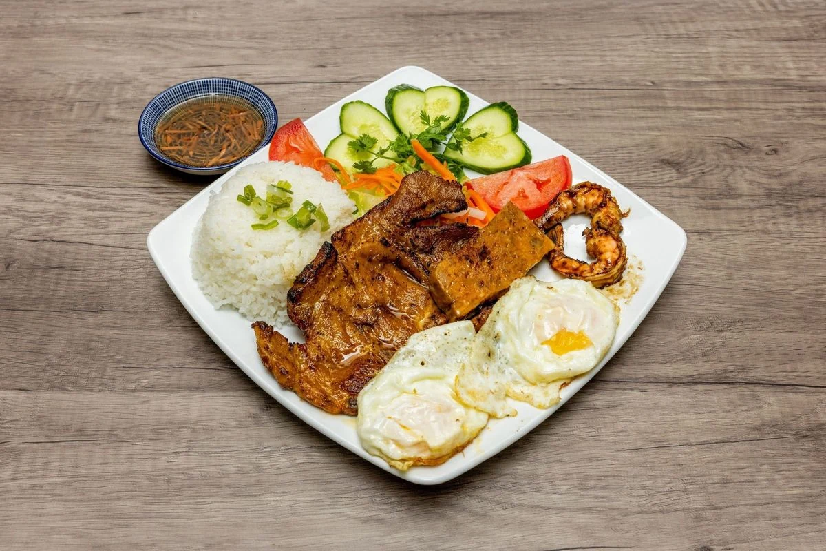 Special Broken Rice with grilled pork chop and fried egg at Bep & Brew in Airdrie, AB